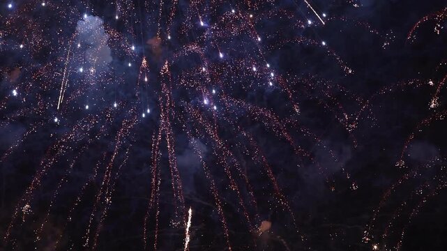 Bright fireworks burst dynamically across a dark night sky with smoky textures, creating a festive display for New Year celebrations, Independence Day events, holiday parties, and grand festivals