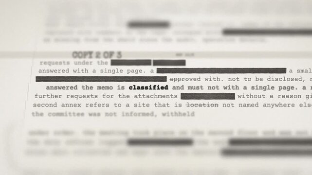 Government dossier with redacted text and a red CLASSIFIED stamp indicating national security secrecy.