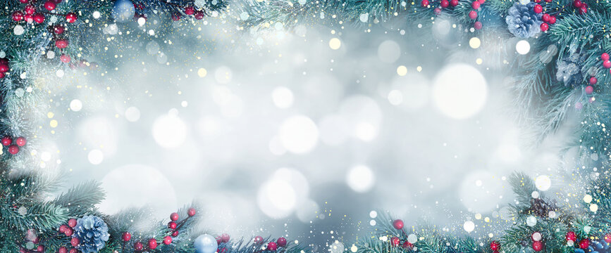 Christmas fantasy Background with frosty fir branches as a frame around blurred lights as copy space