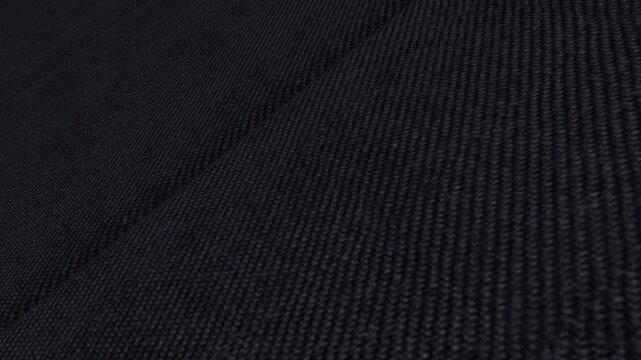 Elegant Cinematic Movement Along Italian Midnight Blue Worsted Wool Twill Fabric with Angled Camera View, Rich Illumination and Fine Diagonal Weave Details