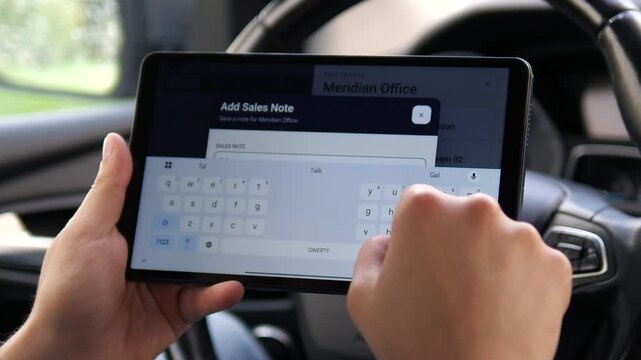 Business professional enters a sales note on a tablet CRM interface, capturing deal updates and customer information as part of a mobile sales workflow.