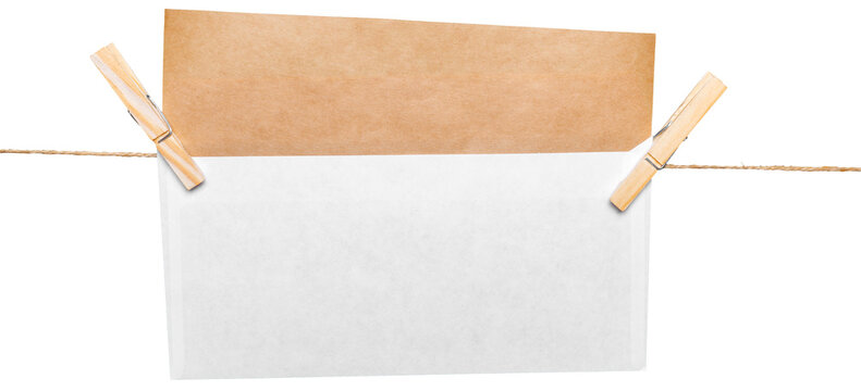 Envelope hanging on a string with clothespins next to a blank space for writing