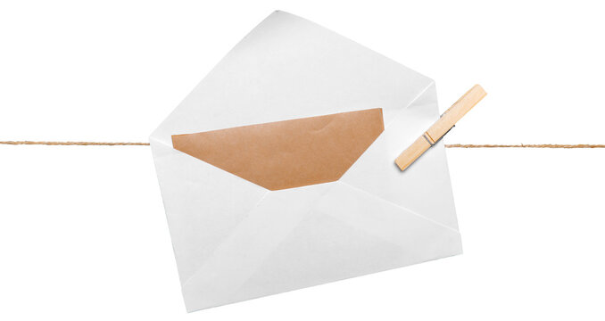 Envelope hanging on a line with a clothespin, showing a brown paper insert, in a simple setting