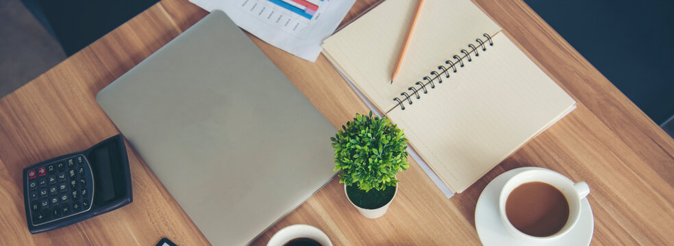 Banner Excel graph with Spreadsheet Document showing Information Financial Startup Concept. Banner Office laptop business financial document chart and graph on office wooden table coffee cup.