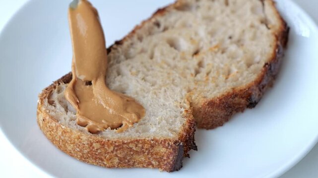 Peanut Butter Spread on Toasted Sourdough Bread Slice with Rustic Crust Open Sandwich