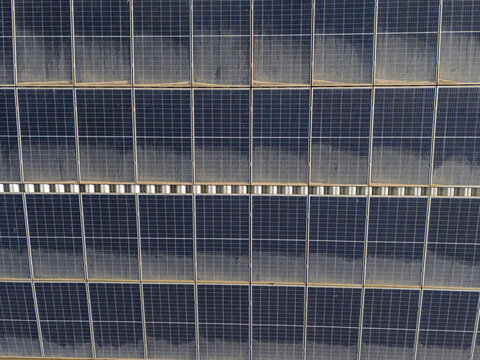 Aerial view of solar panels arranged in a grid pattern at the Chinicato solar farm in Lagos, Faro, Portugal.