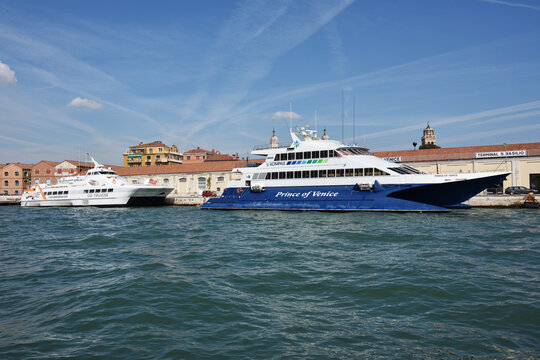 Venice, Italy - Sept 21, 2014: The luxury yacht Prince of Venice and San Frangisk ferry moored in the Venetian port at morning. More than 10 million tourists visit Venice every year