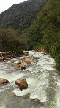Vertical aerial view of boulder strewn river rapids Ecuador
