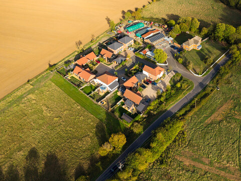 Interesting drone view of a small and exclusive housing development in the heart of rural Essex, UK. Once farm buildings, the site is now home to a dozen or so private homes.
