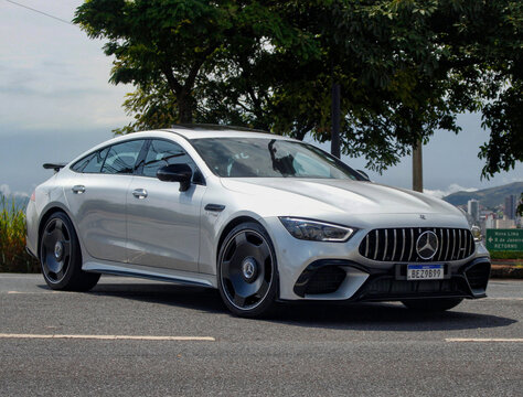 Silver Mercedes-AMG GT 4-Door Coupe Sports Sedan Front Three-Quarter View Parked On Asphalt Scenic Overlook Roadside