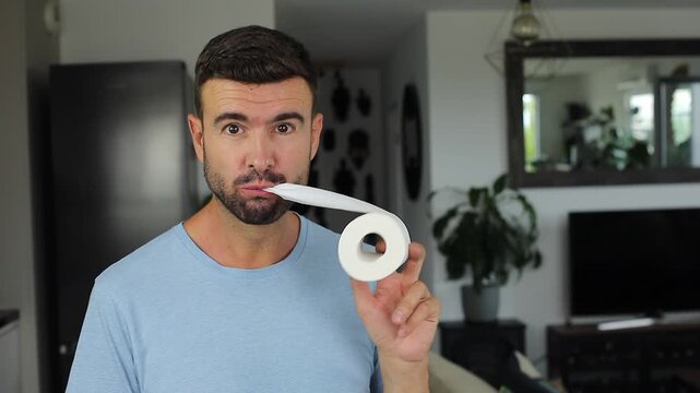 Man Eating Toilet Paper in Living Room