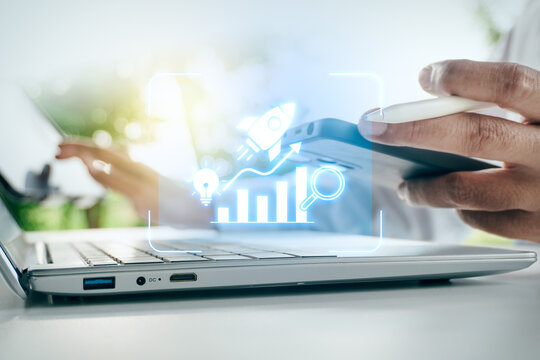 Businessman holding smartphone and stylus near laptop with digital startup rocket launch and growth chart interface in outdoor setting, concept of business innovation and strategy, Growth Hacking.