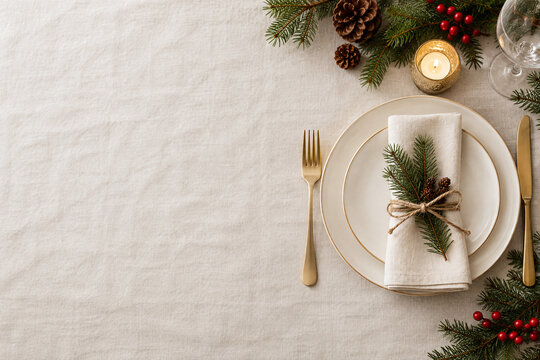 Christmas table setting on white linen with copy space