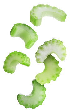 Pieces of celery stalk falling against transparent background