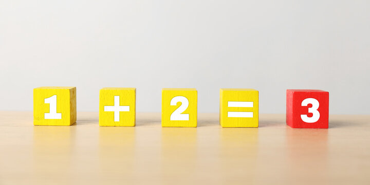 Mathematical equation made with colorful cubes on wooden table background. Banner design