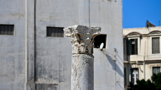 Single Corinthian Order Column with Same Color Modern Building in Background