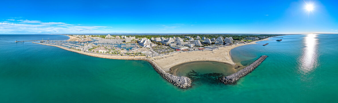 Aerial view of La Grande-Motte pyramidal architecture and Mediterranean coastline in south France 
