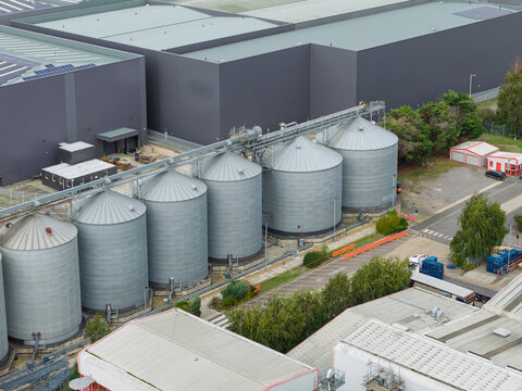 Aerial view of grain silos next to a large industrial warehouse in the United Kingdom.