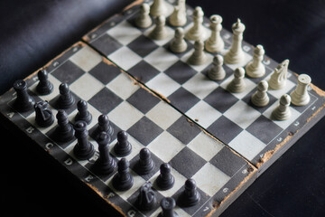 A chessboard against a black background. a game that relies on strategy and intellect. © Randa