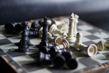 A chessboard against a black background. a game that relies on strategy and intellect. © Randa