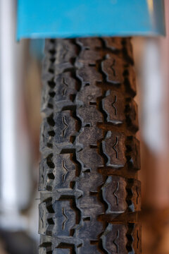 Macro view of vintage motorcycle rubber tire tread pattern illustrating classic vehicle maintenance road safety and retro transport engineering
