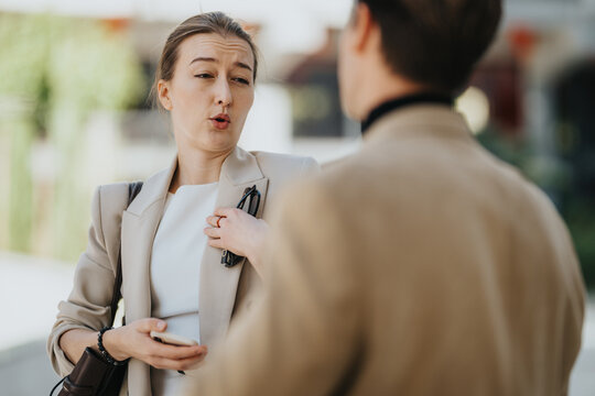 Woman argues with a man during an outdoor business conflict, expressing complaint, disagreement and communication breakdown.