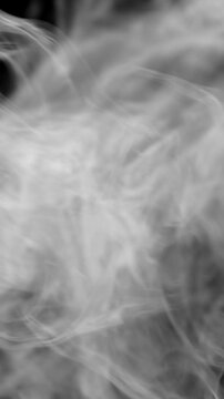 White, natural steam or smoke rising across the entire width of the screen, as if from a fire, a blaze, or a boiling dish. Vertical view.