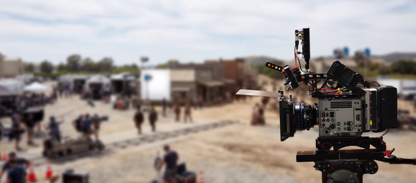 Film production banner featuring a professional camera and a film set in the background.