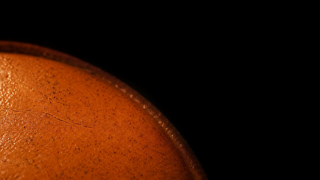 Pumpkin pie custard surface macro with spice flecks on dark background