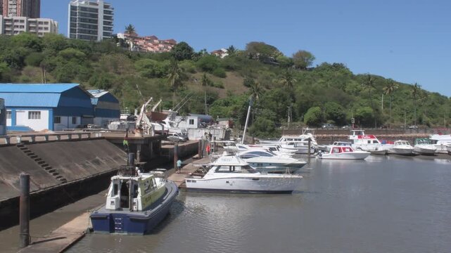 scenic coastal view of the active maputo bay shoreline featuring docked boats, seaside promenades, and maritime infrastructure set against the coastal city skyline