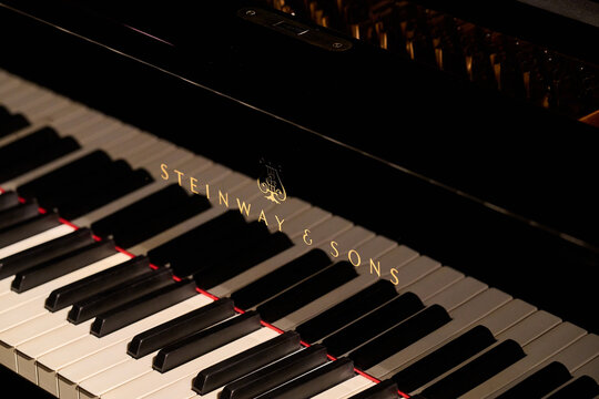 Close-up of Steinway and Sons logo and keyboard on a black grand piano in Rybnik, Poland