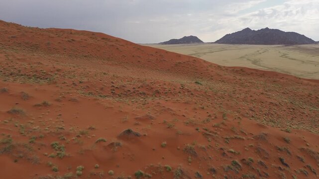 A panorama of sand dunes at sunset. Desert landscape, cloud shadows on the dunes
