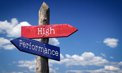High performance - wooden signpost with two arrows, sky with clouds © PX Media