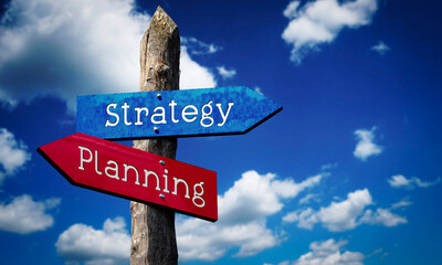 Strategy and planning - wooden signpost with two arrows, sky with clouds © PX Media