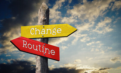 Change or routine - wooden signpost with two arrows, sunset sky in background © PX Media