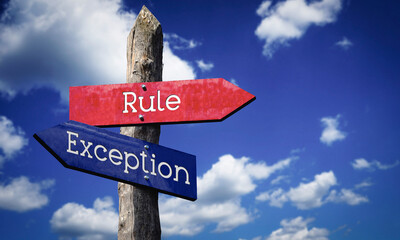 Rule or exception - wooden signpost with two arrows, sky with clouds © PX Media
