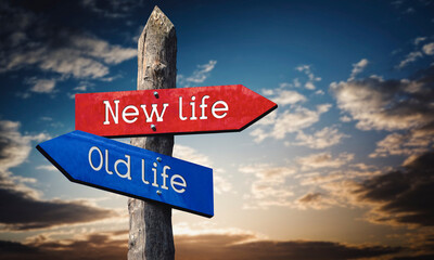 New or old life - wooden signpost with two arrows, sunset sky in background © PX Media