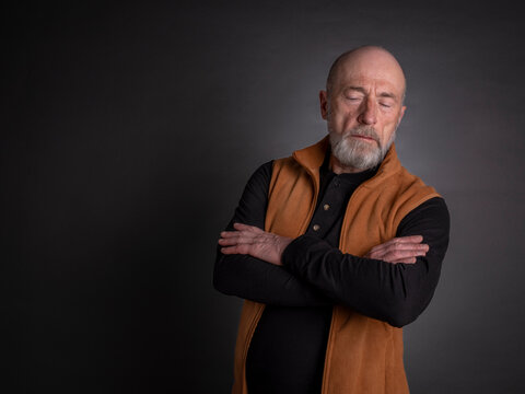 portrait of a serious, bearded senior man deep in thoughts, reflective pose