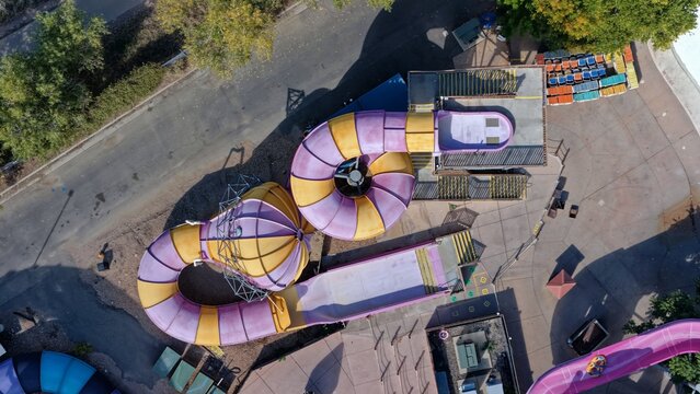 Aerial view of a colorful purple and yellow water slide at an amusement park in Denver, Colorado, United States.
