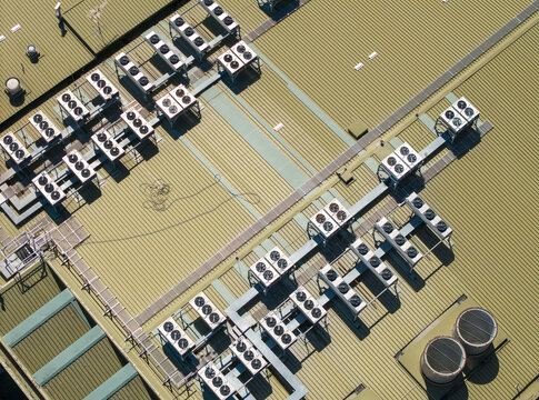 Aerial view of a data center roof featuring numerous HVAC cooling units and ventilation systems arranged in rows on a corrugated metal surface in Melbourne, VIC, Australia.