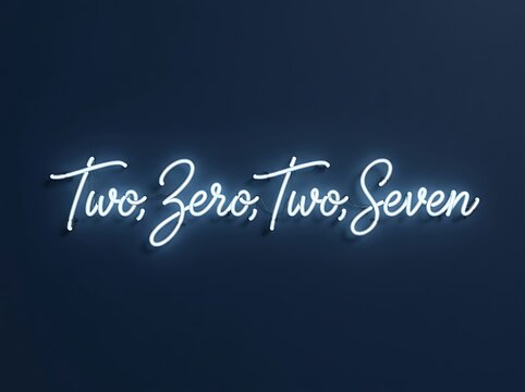 Neon sign script font text spelling two zero two seven glowing against a dark blue background