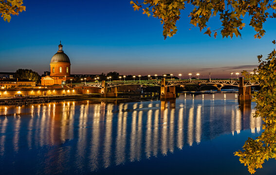 Toulouse, France - The illuminated Saint-Pierre Bridge and the Dome de la Grave in Toulouse at blue hour