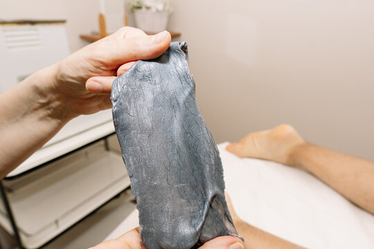 Wax strip for removing unwanted leg hair on a man's leg