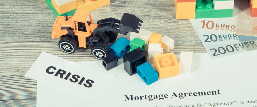 Houses made of toy blocks, mortgage agreement form and money. High prices building or purchase home and crisis on real estate market