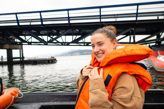 Woman smiling in life jacket on boat