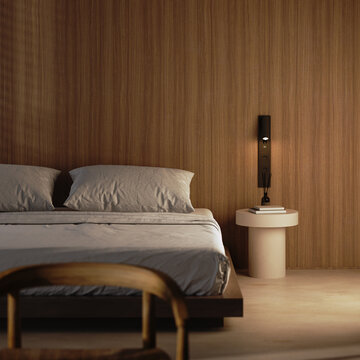 Bedroom interior with wooden wall and warm bedside lighting
