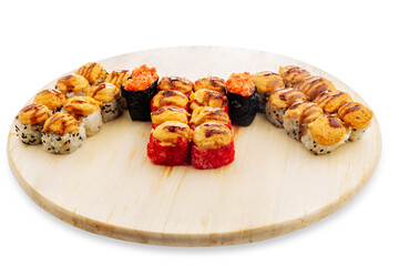 Assorted sushi rolls arranged on a round wooden serving board with colorful toppings and rice details, isolated food presentation viewed from above on white © Кирилл Горшков