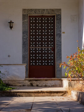 Commercial photograph of a classic, charming old house entrance in Athens, ideal for real estate listings, travel media, and historic architecture features.