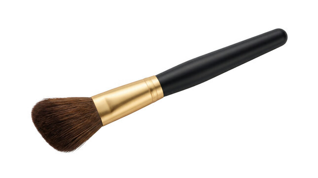 Angled makeup brush with black handle and gold ferrule against a bright studio light Isolated on transparent background