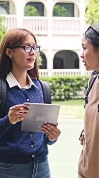 Female Student Using Tablet Outdoors on University Campus